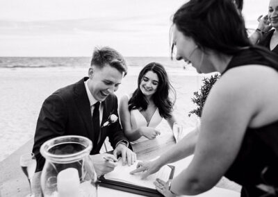 Bride and Groom signing at their wedding at The Sandbar Beach Cafe